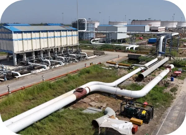 Station building and pipelines across a green, well-kept terminal site
